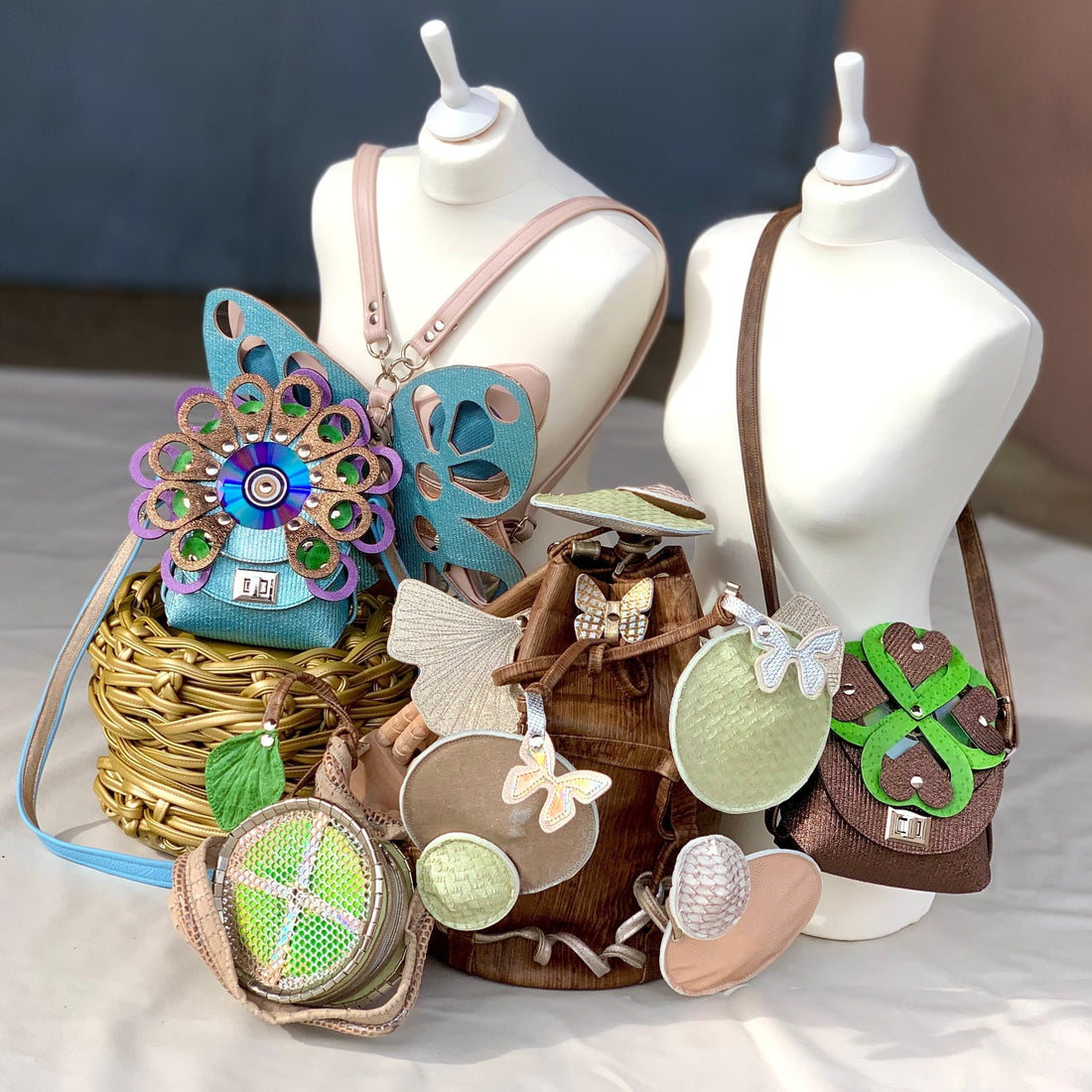 Wearable art bag collection featuring sculptural leather bags with holographic details, designed as wearable sculptures